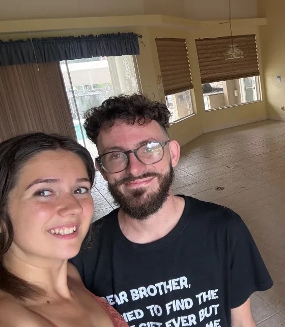 Josh smiling alongside Leah inside a home during a property visit.